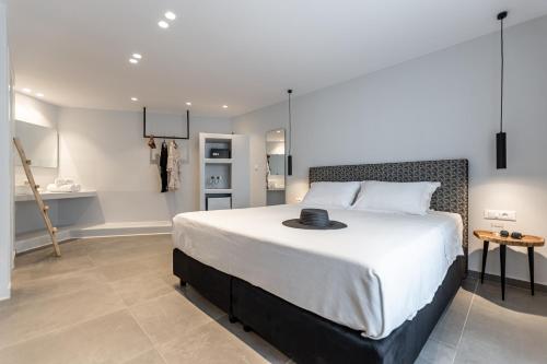a bedroom with a large bed with a hat on it at Lianos Village in Agios Prokopios