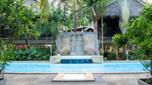 a fountain in the middle of a pool at Long Beach Chalet - SHA Extra Plus in Ko Lanta