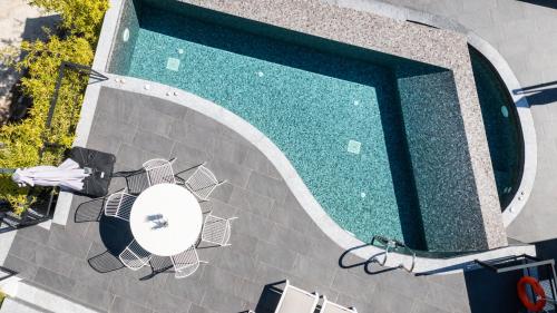 an overhead view of a pool with chairs and a table at Ionian Grand Villas - Villa Estella in Lygia