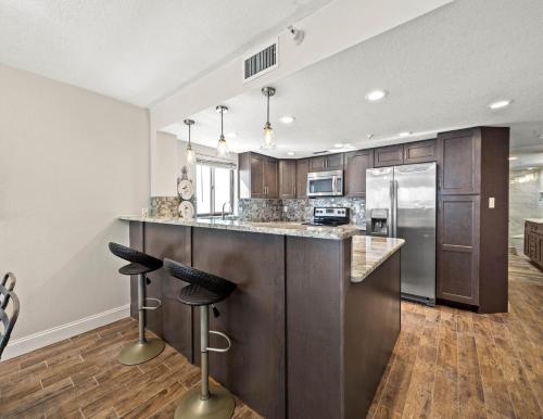 a kitchen with a large island with bar stools at Arie Dam 404 in St. Pete Beach
