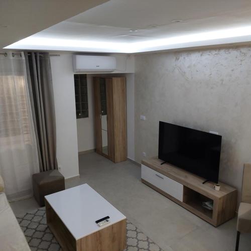 a living room with a flat screen tv on a wall at Apartman LUX Jelena in Surčin