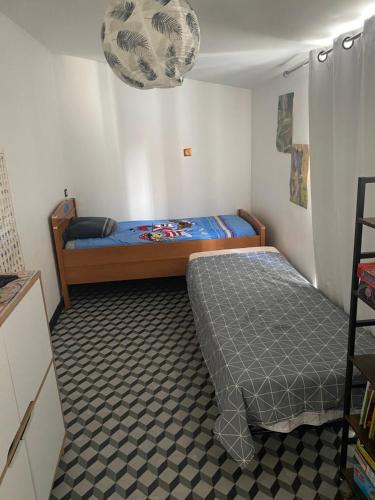 ein Schlafzimmer mit einem Bett und einer Etage in der Unterkunft Appartement chaleureux au cœur de la ville in Saintes