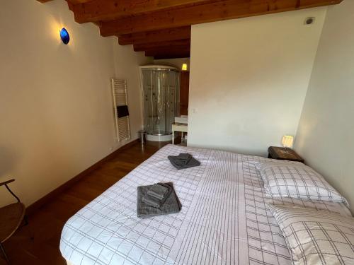 a bedroom with a large bed with a wooden ceiling at Apartment Cascade 3 minutes from Alpe d Huez Grand Domaine via Oz en Oisans in Oz