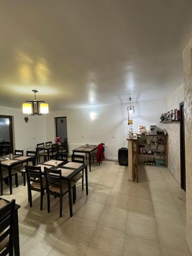 a restaurant with tables and chairs in a room at Pensiunea Sarah - Muntele Mic in Muntele Mic