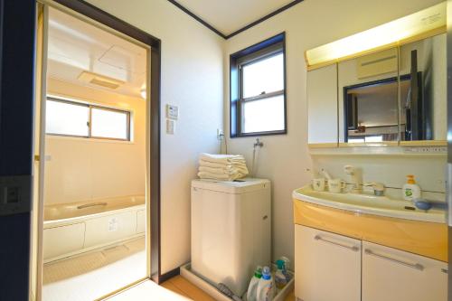 een badkamer met een wastafel, een toilet en een bad bij Maple Hotel Osaka in Osaka