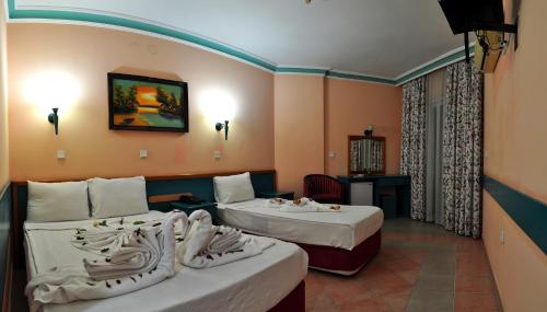 En eller flere senger på et rom på KLEOPATRA SUNLIGHT HOTEL