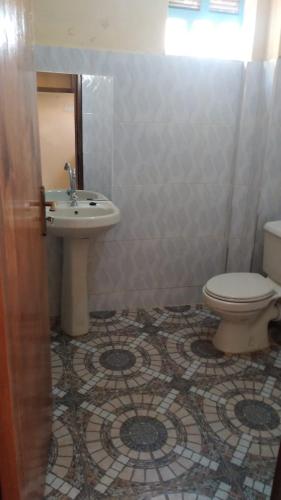 a bathroom with a sink and a toilet at VILLA DE LEO in Bungoma