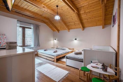 a room with two beds and a table in it at Chalet Bystra - wellness 5 min-washer-game room-view-5 bedrooms in Mýto pod Ďumbierom