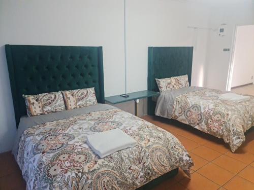 Letto o letti in una camera di HASATE GUEST HOUSE 13 LOUWVILLE STREET BELLIVILLE Cape Town south Africa