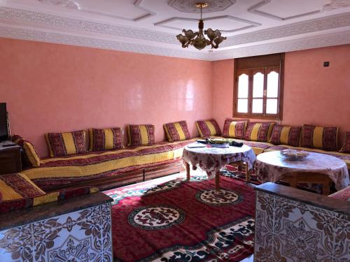 a living room with a couch and two tables at Zino house in Khouribga