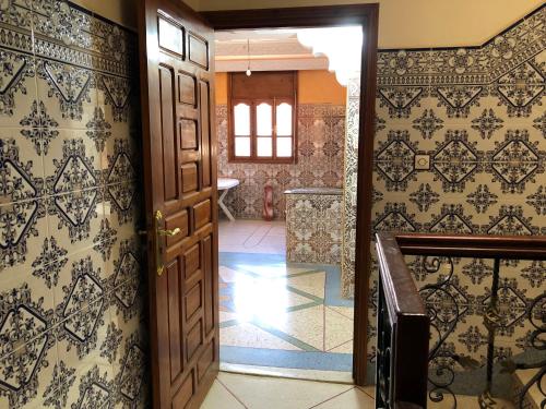 an open door in a room with wallpaper at Zino house in Khouribga
