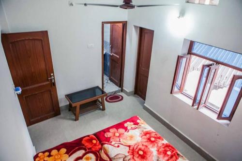 a room with a bed and a mirror and a door at Rama Guest House in Bodh Gaya