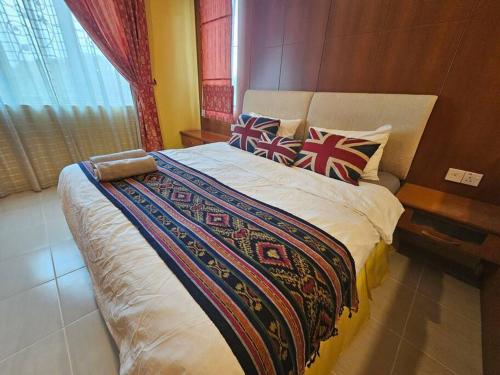 a bedroom with a large bed with pillows on it at Lovely Luxury Detached House Vivacity Kuching in Kuching