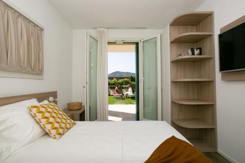 a bedroom with a bed and a sliding glass door at Casa Massaro Todeschini in Abano Terme