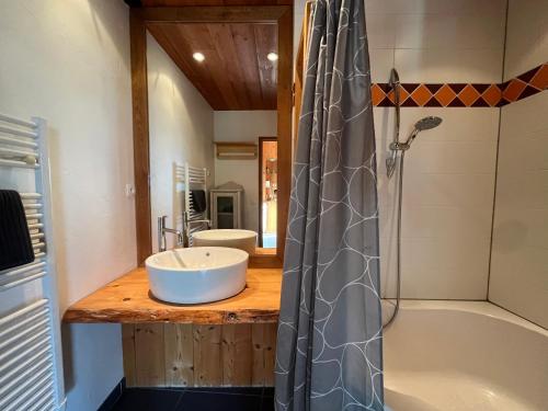 a bathroom with a sink and a tub and a shower at Apartment Belledonne 3 minutes from Alpe d Huez Grand Domaine via Oz en Oisans in Oz