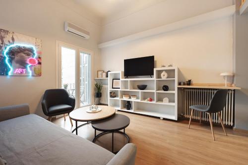 a living room with a couch and a table at Aristotelous 22 Suites in Thessaloniki