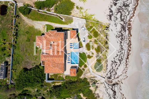 an aerial view of a house on the beach at 10 bed-rooms luxury BEACH VILLA in Guana Bay