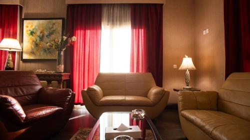 a living room with leather furniture and a window at The Villa 604 Powered by look in Cairo
