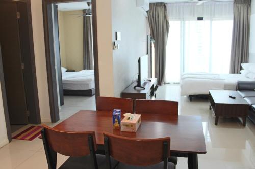 a room with a table and a room with a bedroom at Sausana Suites D' Bliss in Johor Bahru