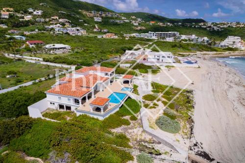 an aerial view of a house on the beach at 10 bed-rooms luxury BEACH VILLA in Guana Bay