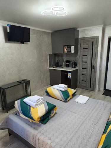 a bedroom with two beds and a kitchen at Apart 41 in Almaty