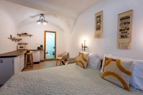 a bedroom with a large bed and a kitchen at Casa Maya Transilvania in Sighişoara