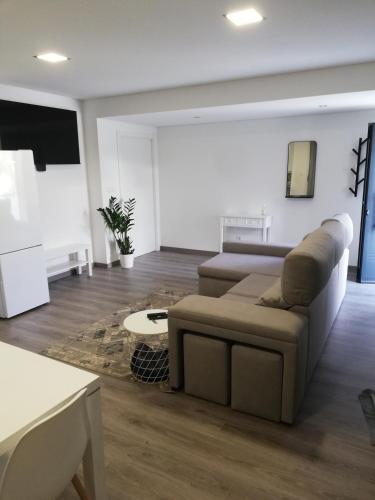 a living room with a couch and a table at CasaMaeDouro in Peso da Régua