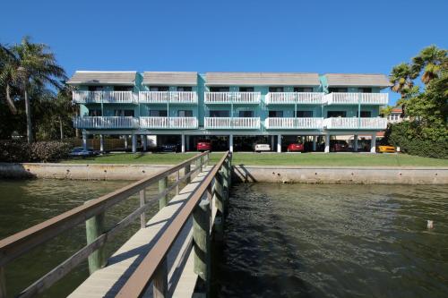 a large building next to a body of water at Anna Maria Island Beach Palms 2B in Bradenton Beach