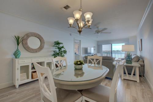 a dining room and living room with a table and chairs at Anna Maria Island Beach Palms 2B in Bradenton Beach