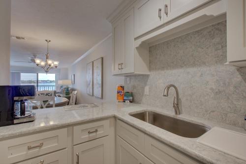 a kitchen with white cabinets and a sink at Anna Maria Island Beach Palms 2B in Bradenton Beach