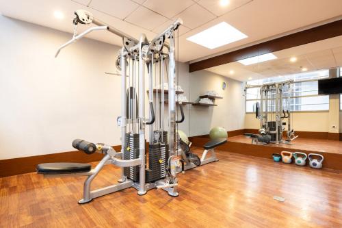 a room with a gym with exercise equipment at Holiday Inn Santiago - Airport Terminal by IHG in Santiago