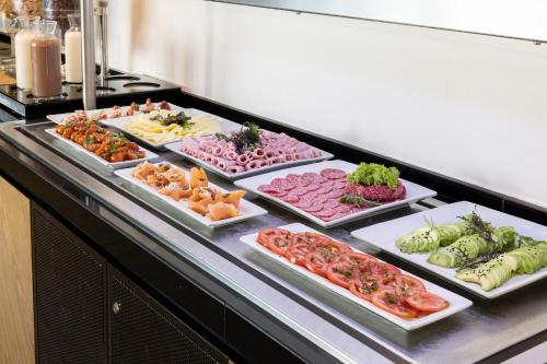 a buffet line with many different types of food at Holiday Inn Santiago - Airport Terminal by IHG in Santiago