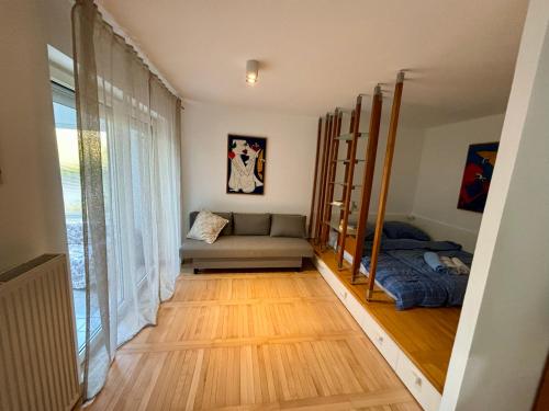 a living room with a couch and a bed at Comfy flat in city-FREE parking in Ljubljana