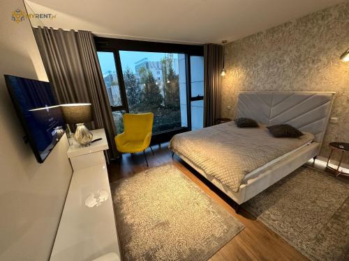 a bedroom with a bed and a large window at UNIA ART Apartament 61 - BASEN, SPA in Lublin