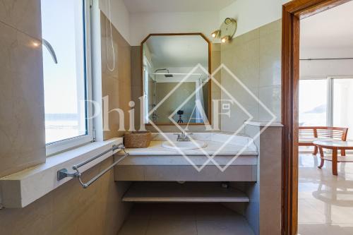 a bathroom with a sink and a mirror at 10 bed-rooms luxury BEACH VILLA in Guana Bay