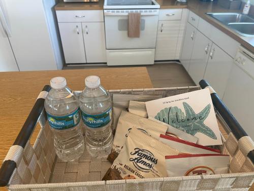 a basket with two bottles of water on a table at Escape to an island adventure! Free bikes & beach items in Anna Maria