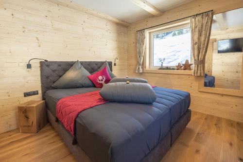 a bedroom with a bed in a wooden room at Grubi´s Chalet Alm in Gerlos