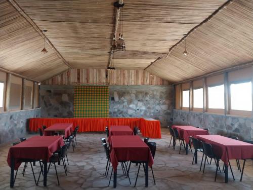 a large room with red tables and chairs in it at Resian Mara Camp in Talek