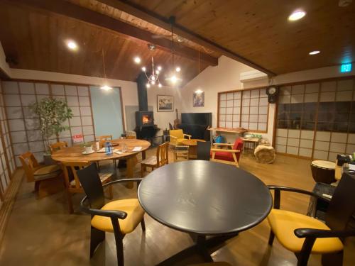 a room with tables and chairs in a restaurant at kakayama hutte in Muraoka
