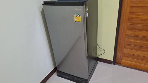a refrigerator in the corner of a room at Hatyai.Muslim.Home in Hat Yai