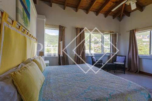 a bedroom with a large bed and a window at 10 bed-rooms luxury BEACH VILLA in Guana Bay