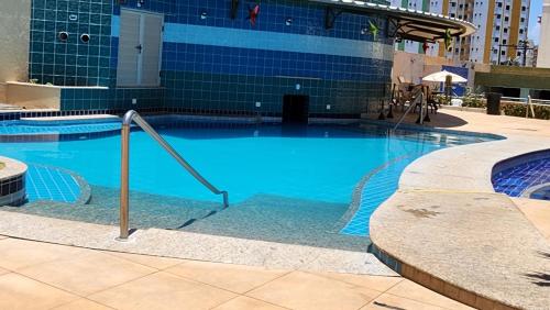 a large blue swimming pool in front of a building at Prive das Thermas - 301B in Caldas Novas