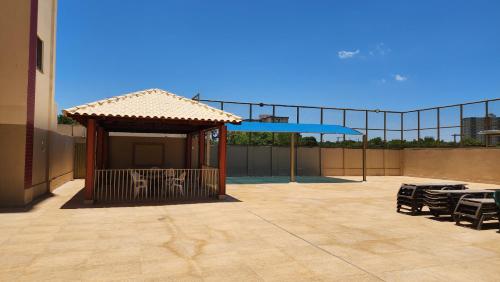 a gazebo with chairs and a canopy on a patio at Prive das Thermas - 301B in Caldas Novas