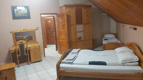 a bedroom with two beds and a dresser in it at Почивна станция - ТЕЦ Бобов дол in Bistriza