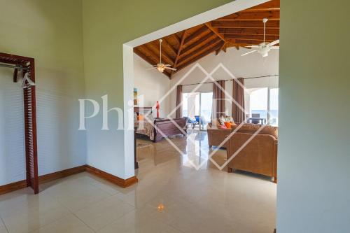 a living room with a couch and a table at 10 bed-rooms luxury BEACH VILLA in Guana Bay