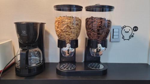 a group of three vases filled with nuts on a counter at 29 Play House in Incheon