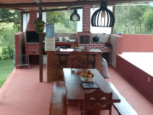 an outdoor kitchen with a table and a counter at Fazenda Riachão in Pojuca