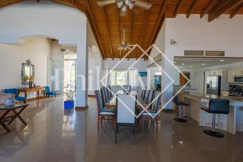 a dining room and kitchen with a table and chairs at 10 bed-rooms luxury BEACH VILLA in Guana Bay