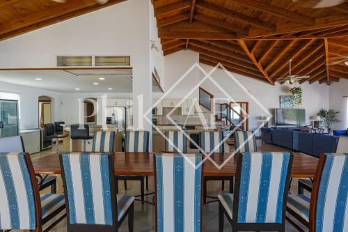 a dining room and living room with a table and chairs at 10 bed-rooms luxury BEACH VILLA in Guana Bay