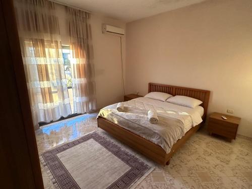 a bedroom with a bed and a large window at Hostel Rinas in Rinas